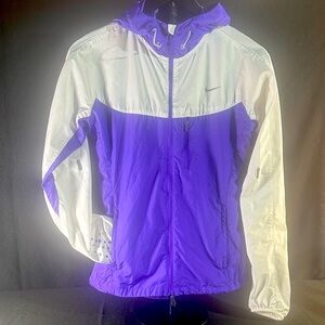 Nike Women's Running Jacket in Purple and White with Reflective Accents.